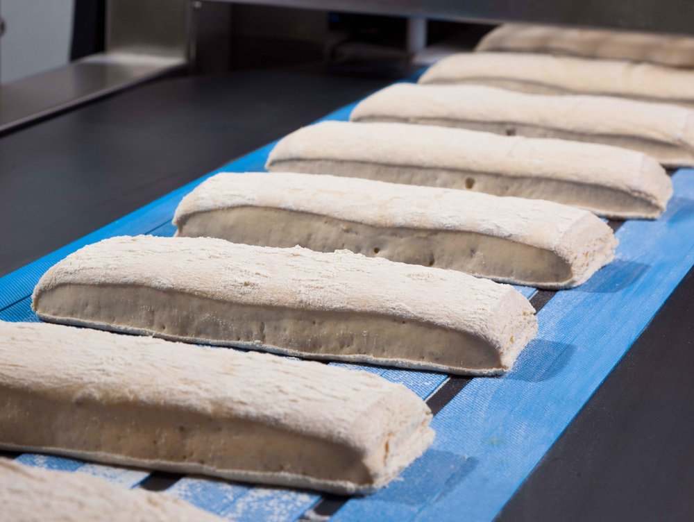 Dough strips are processed extremely gently in the patented S-shaped set of rollers, the open pore structure is preserved Dough strips in S-shaped set of rollers